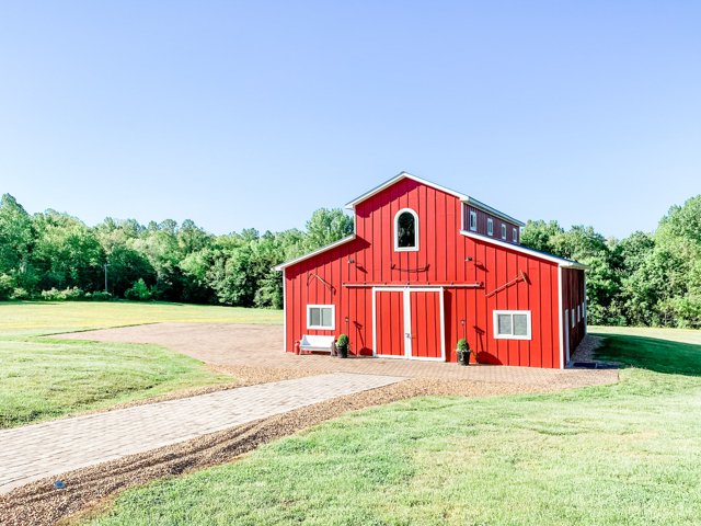 The red Virginia Barn and its open lawn