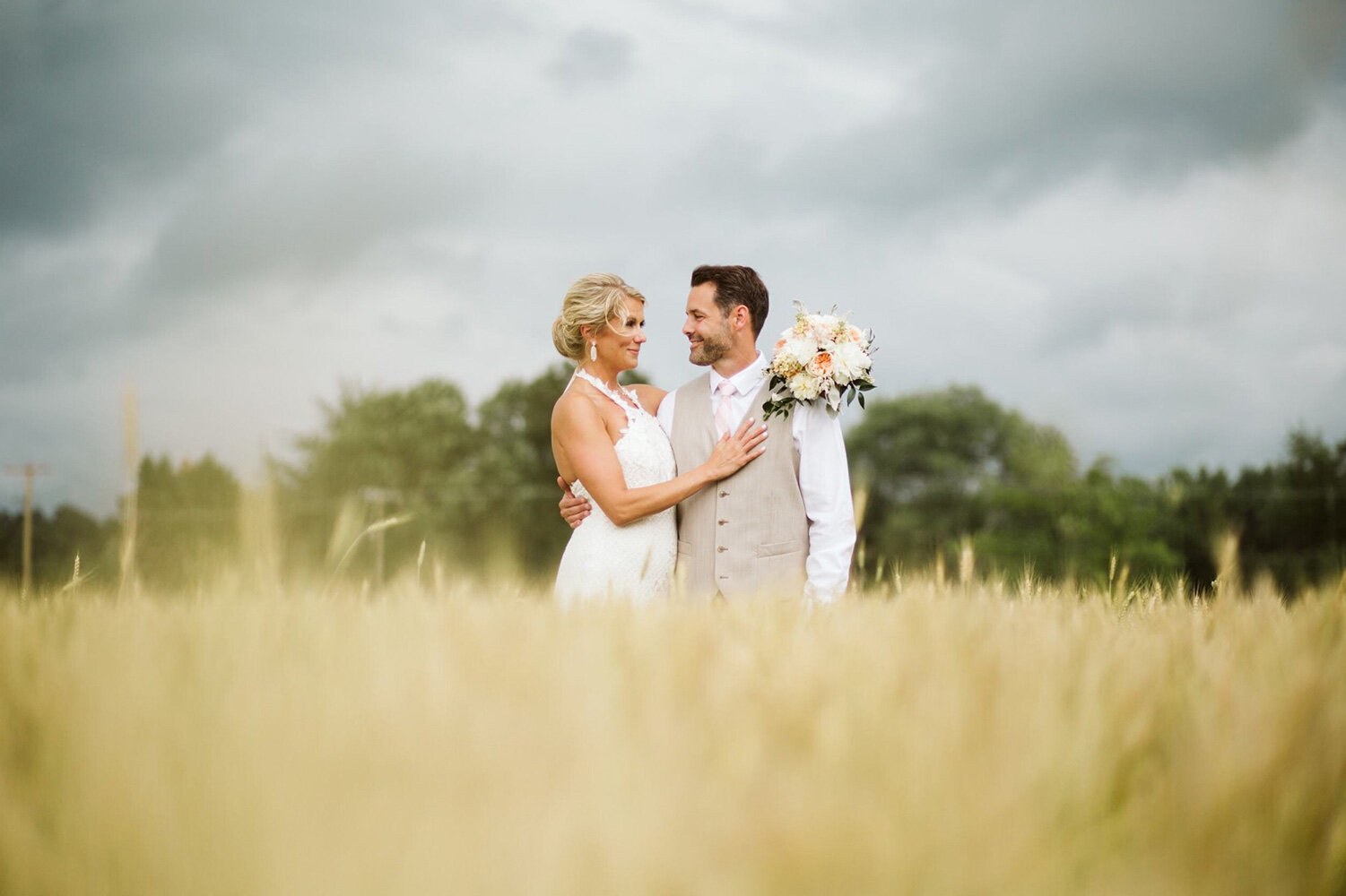 A couple together in the golden fields at South View Farm