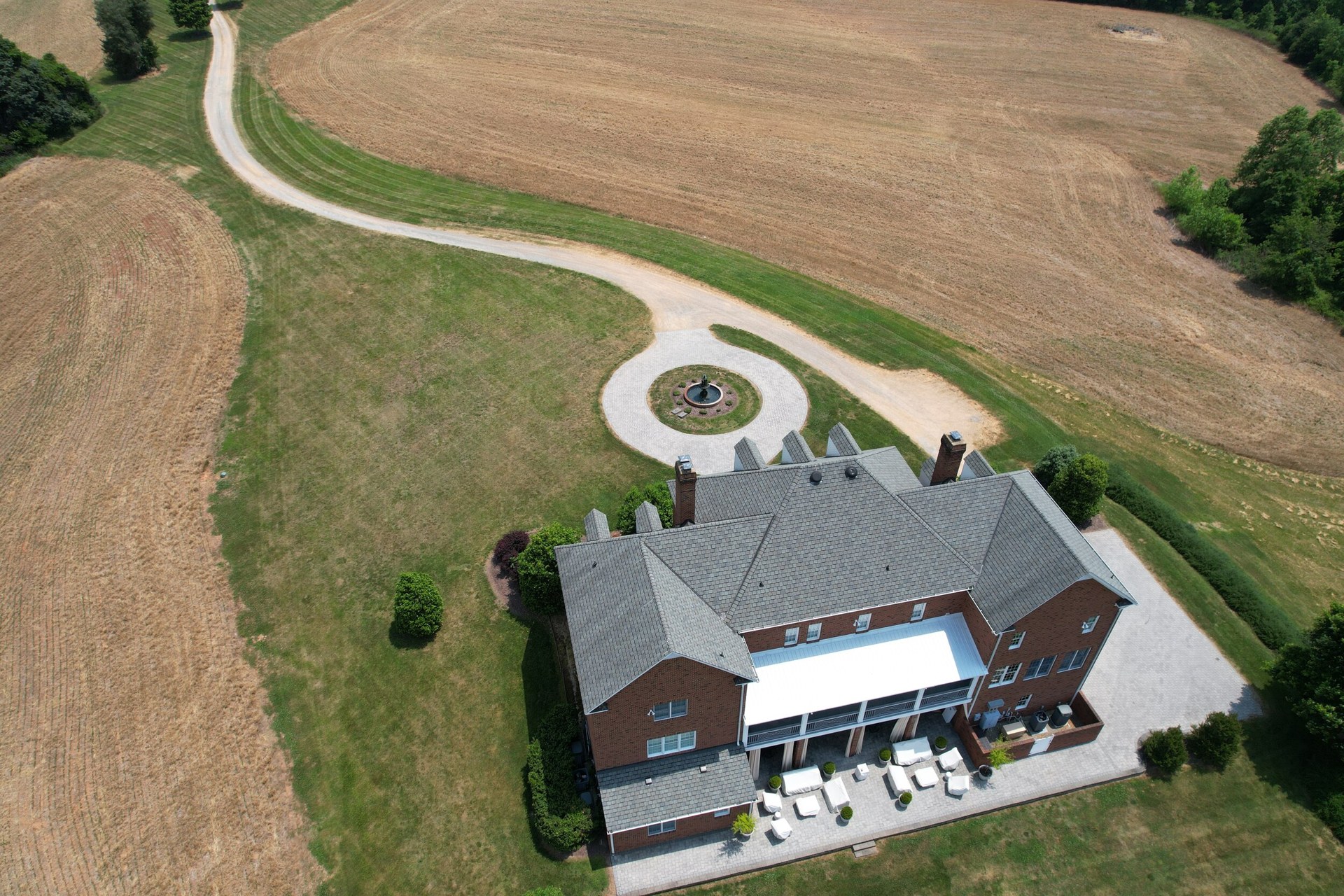 An aerial view of the Manor House, its patio and surrounding countryside