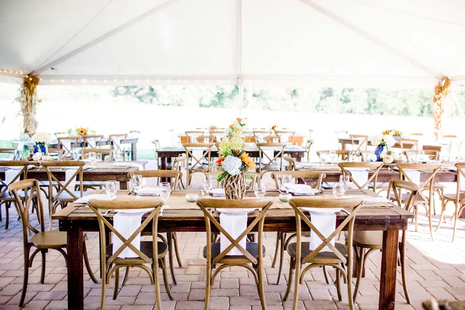 A wedding reception with flowers and long farmhouse tables